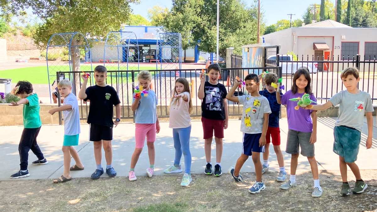 How to tour a private school | Kids making fun poses on a sunny day at Courtyard School